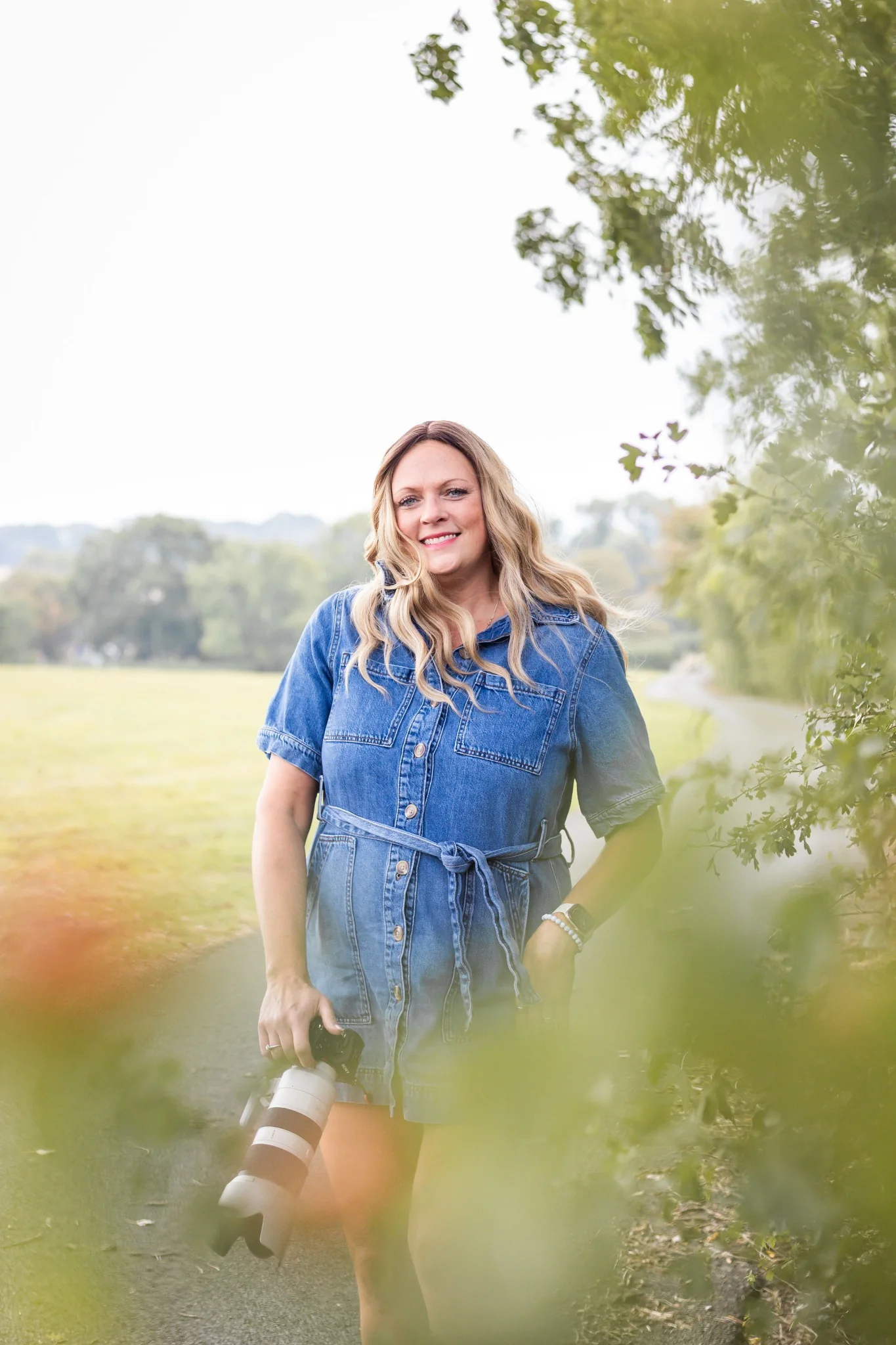 Sarah Johnson holding her camera outdoors