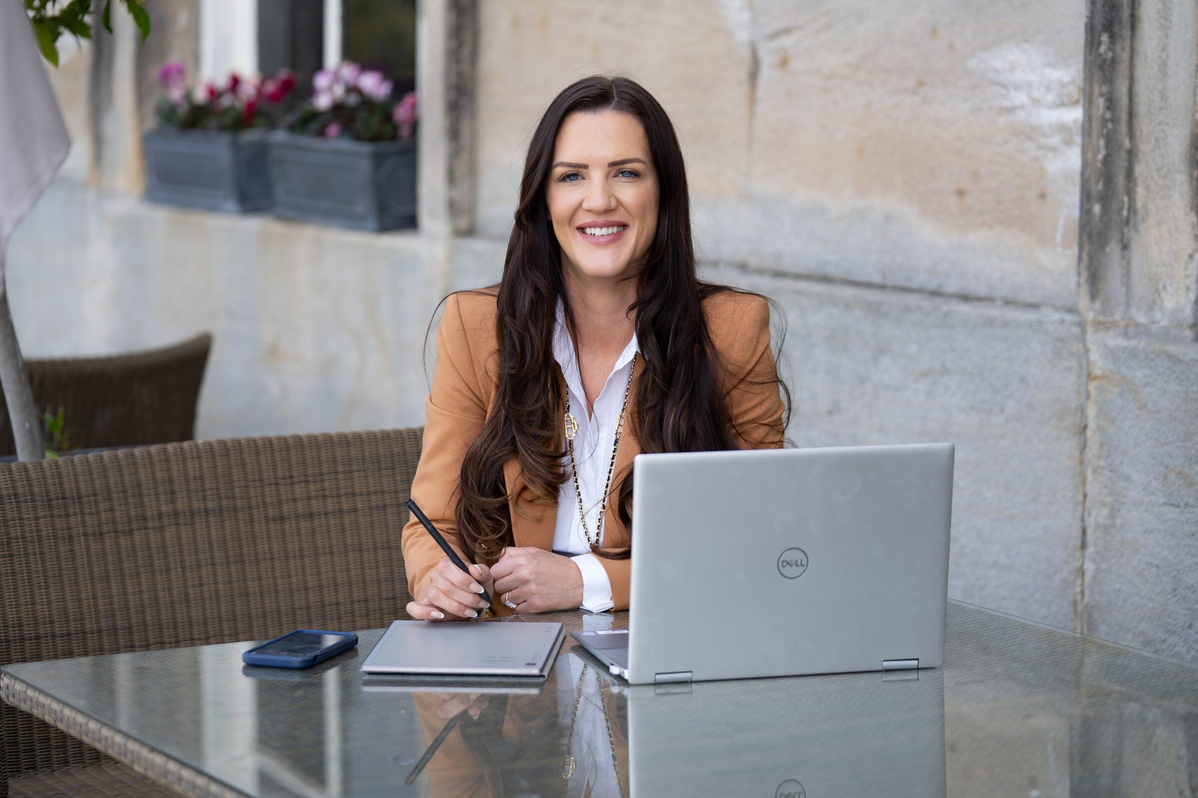 Business owner working outdoors with a laptop during a personal branding shoot