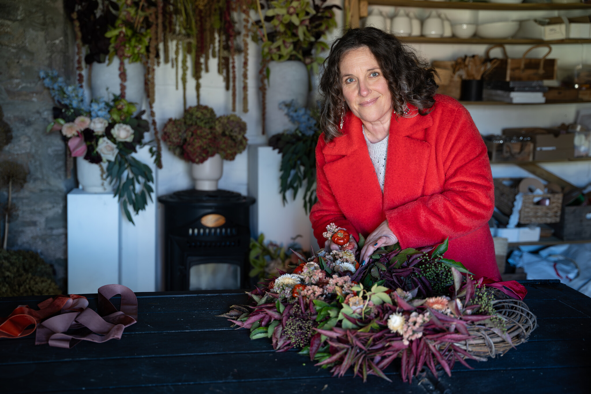 Florist making a wreath during a branding session