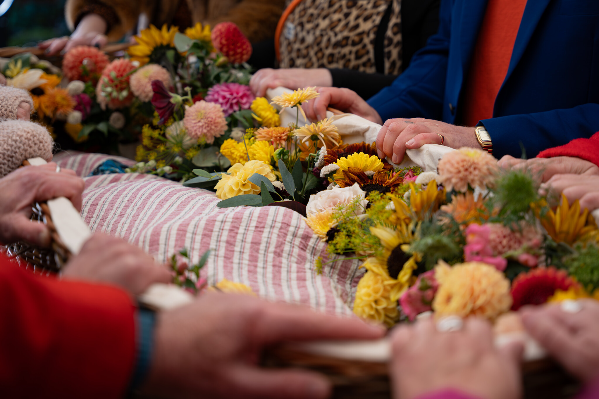 Hands creating flowers during a workshop