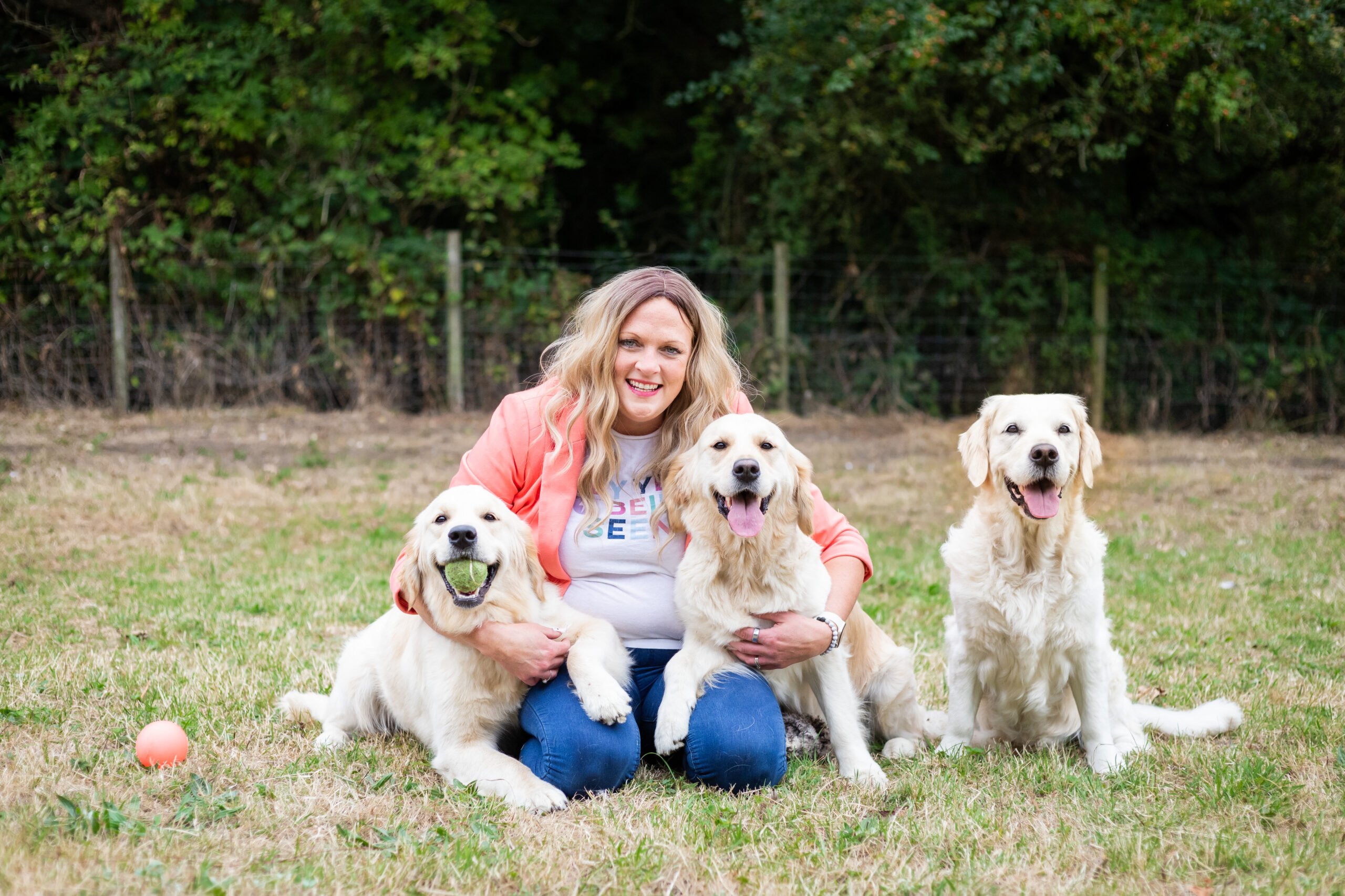 Sarah Johnson with her Golden Retrievers outdoors