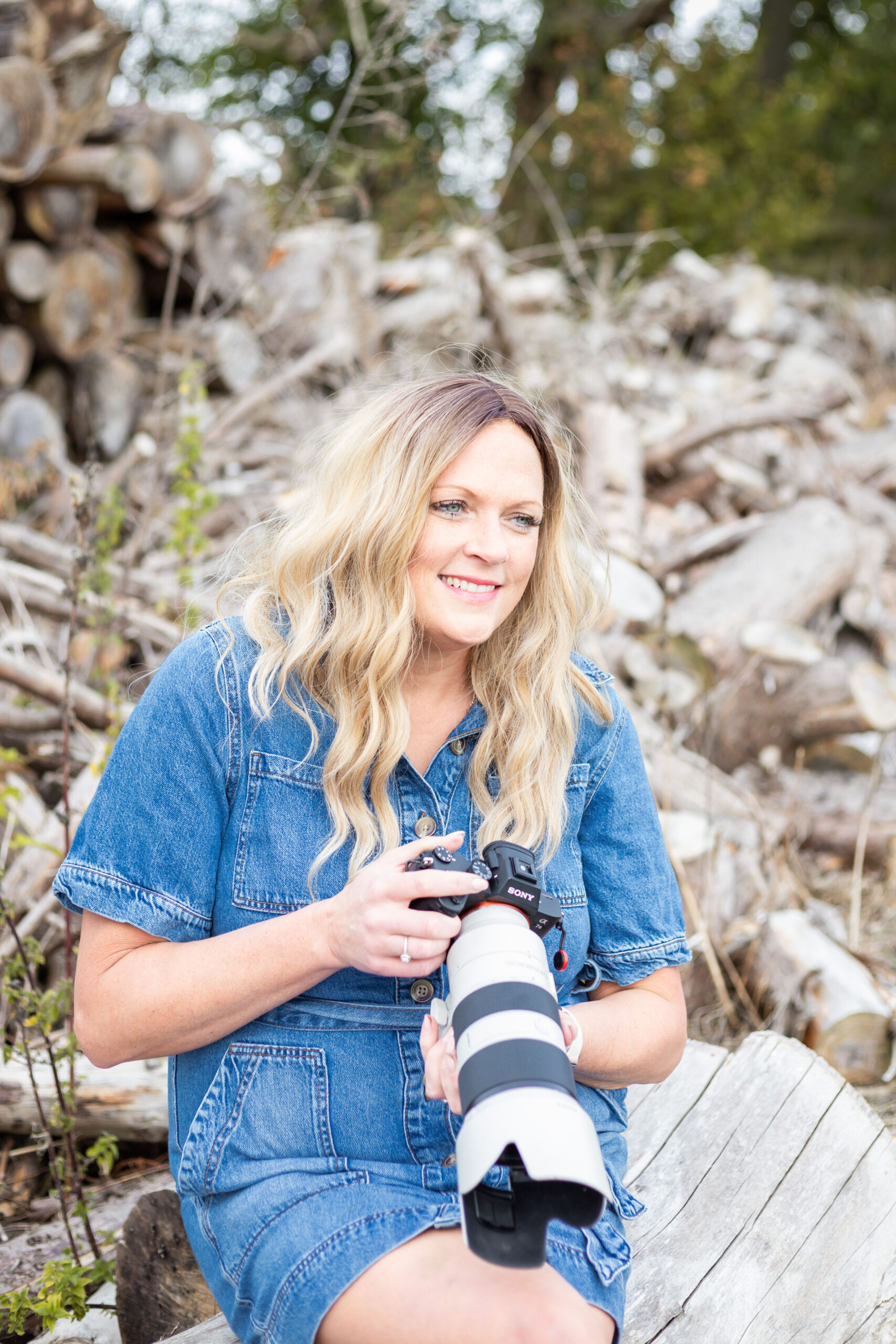 Sarah Johnson holding her camera outdoors