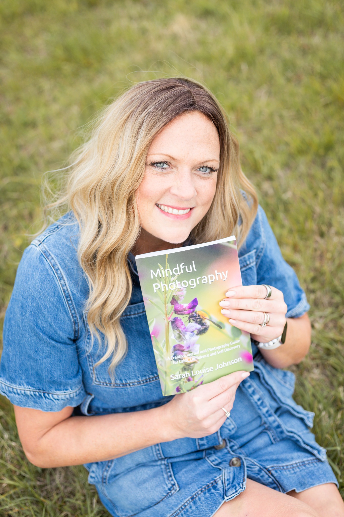 Sarah holding her Mindful Photography book